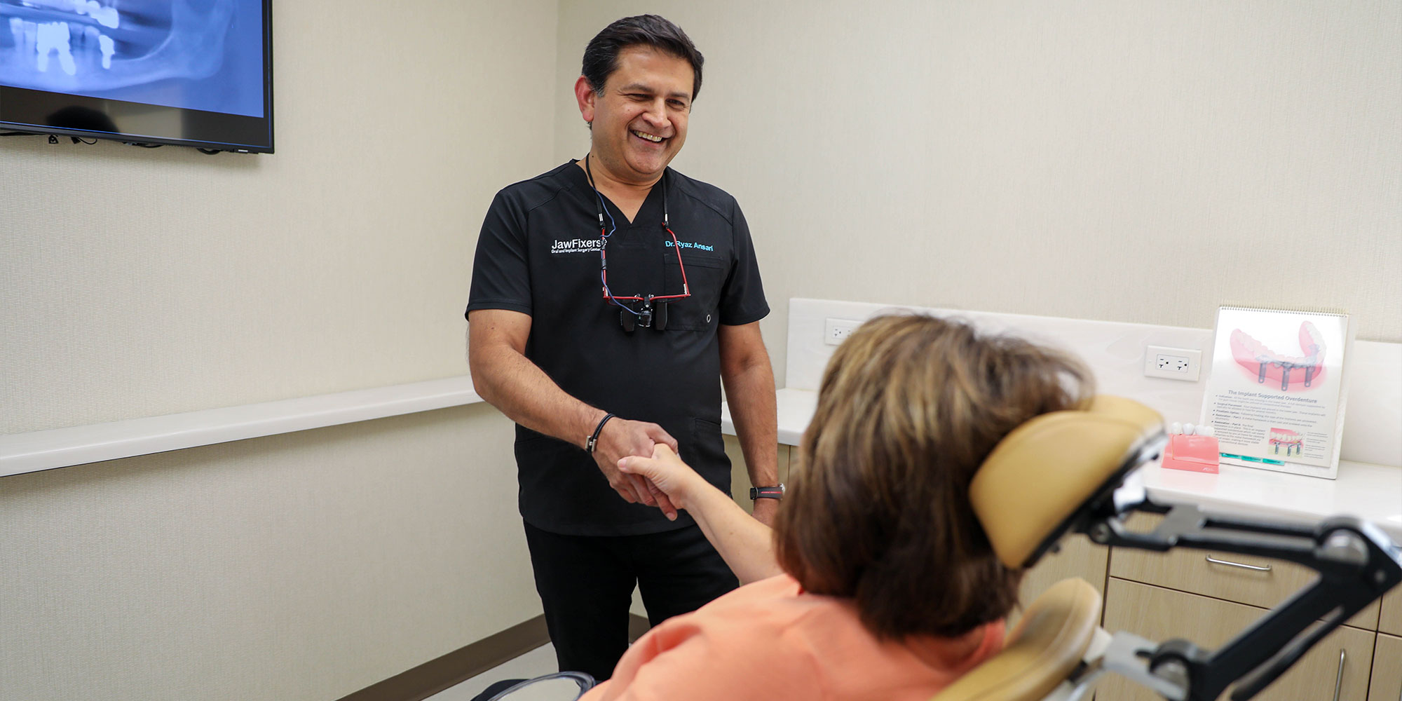 Dr. Ansari Ryaz shaking a patient's hand