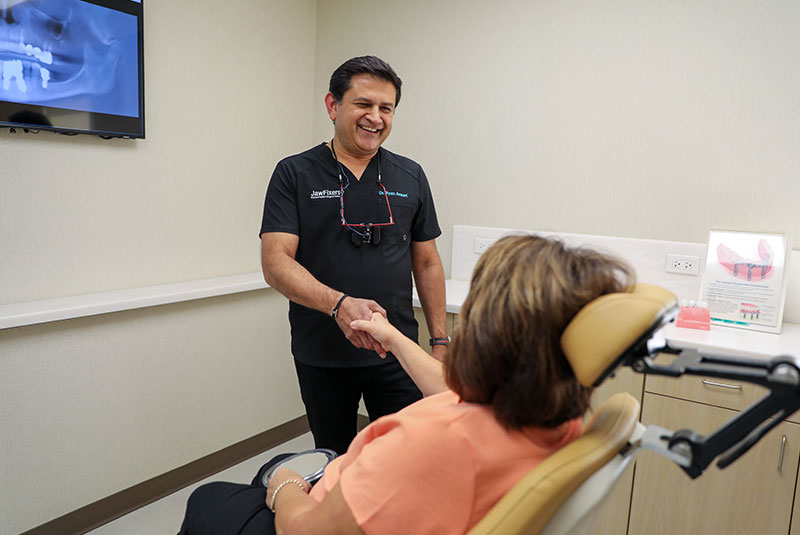 Dr. Ansari Ryaz shaking a patient's hand