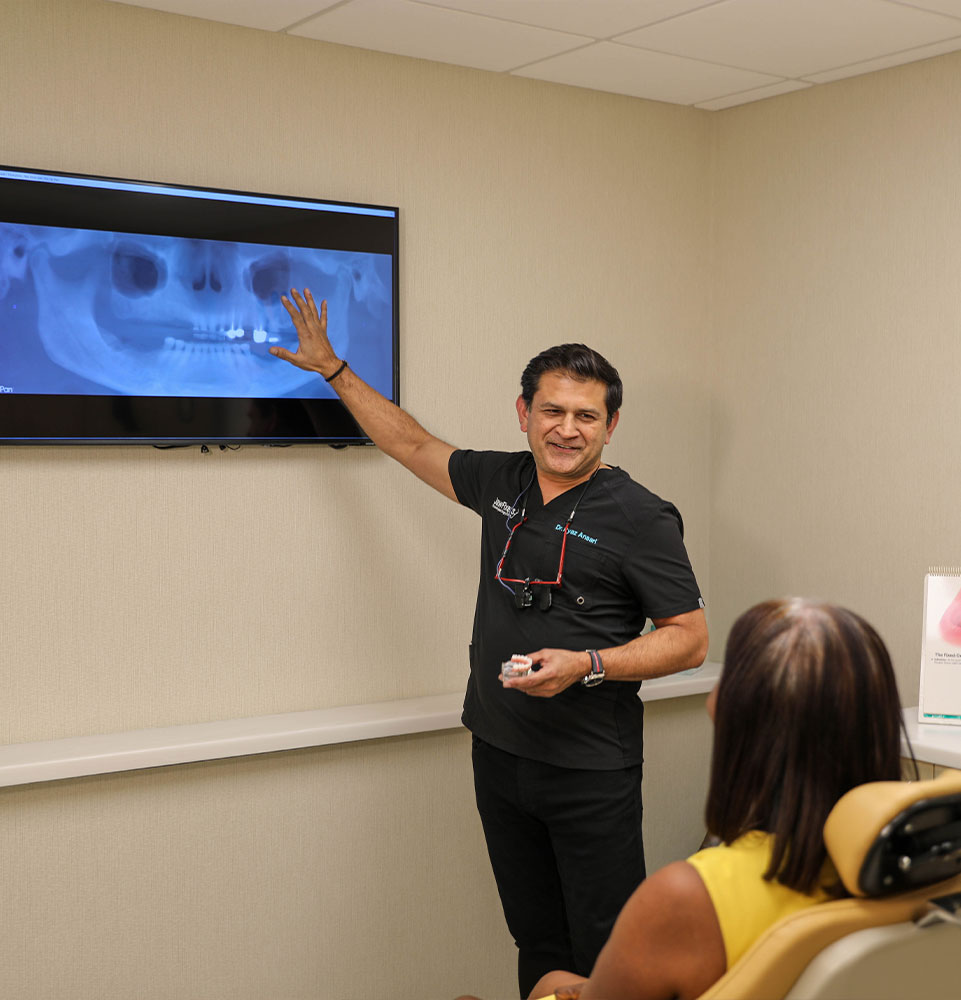 Dr. Ansari Ryaz pointing to x-ray to show patient