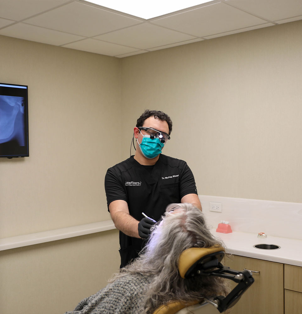 doctor inspecting patients mouth