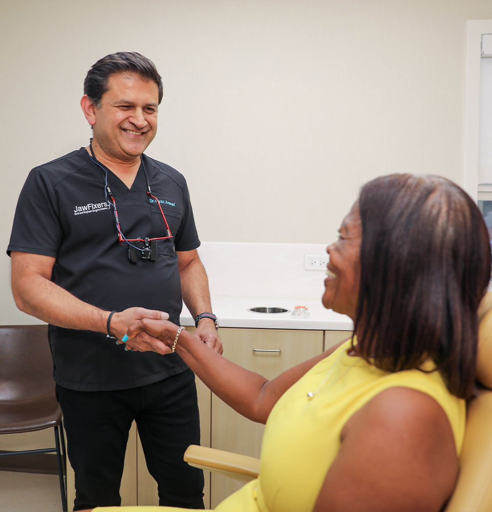 Dr. Ansari Ryaz shaking a patient's hand