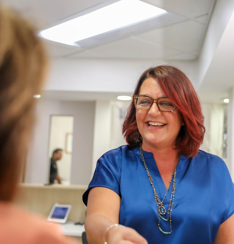 staff member greeting patient into office