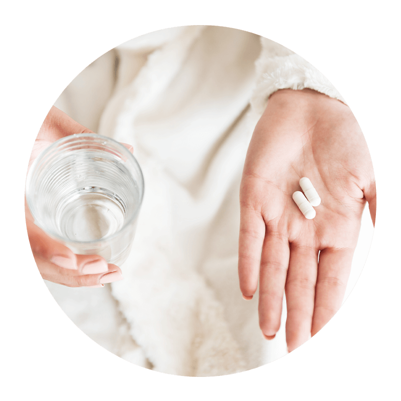 woman about to take medicine for failing dental implants
