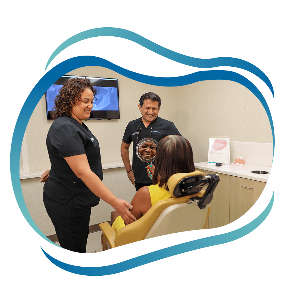 Dr. Ansari Ryaz. givving mirror to patient to see their teeth after dental procedure