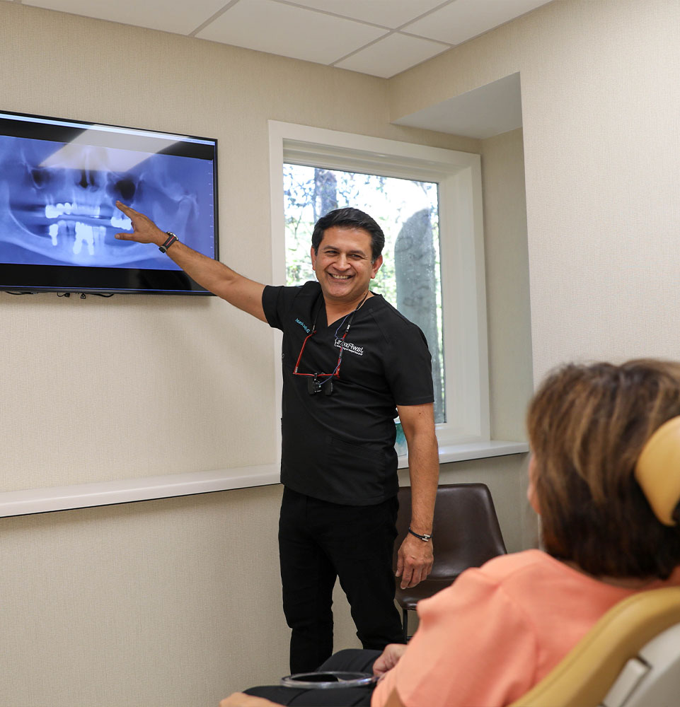 Dr. Ansari Ryaz pointing to x-ray to show patient
