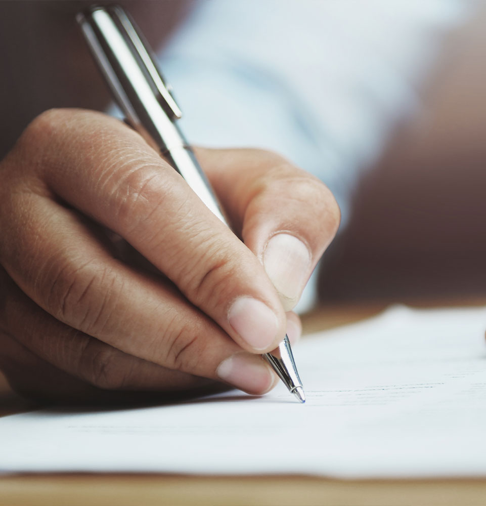 man writing on paper