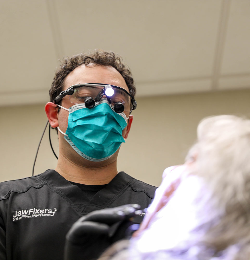 doctor helping a patient with failing dental implants