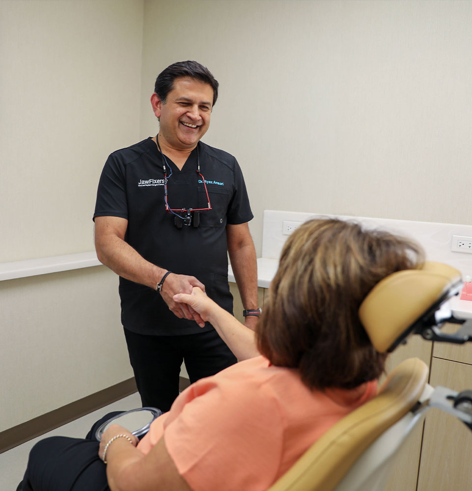 Dr. Ansari Ryaz shaking a patient's hand