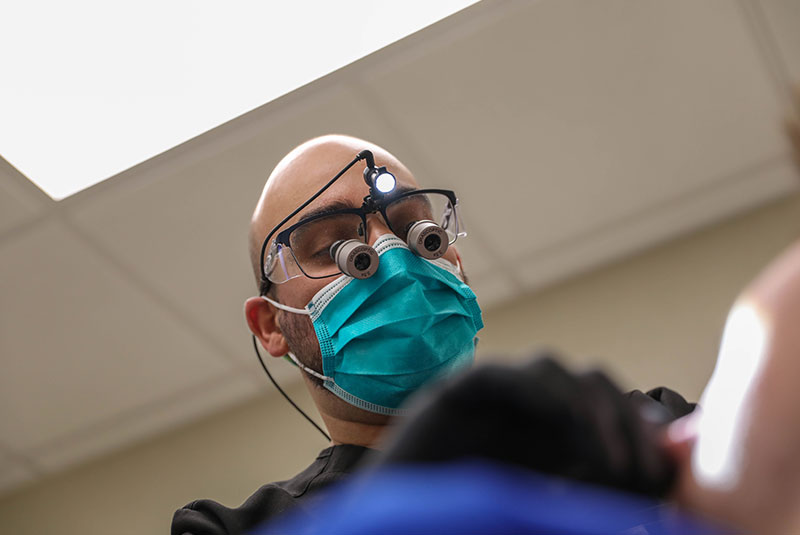 doctor helping a patient with failing dental implants
